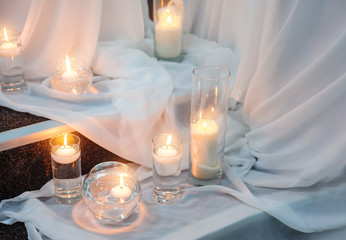 Wedding Lighted candles on transparent tulle