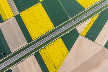 Washable wall murals Aerial photo aerial view of highway and green harvest fields