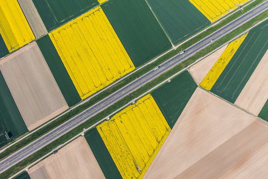 aerial view of highway and green harvest fields