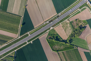 aerial view of highway and green harvest fields