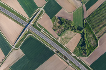 aerial view of highway and green harvest fields