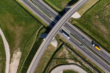 aerial view of highway and green harvest fields