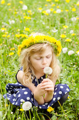 girl blowing dandelion