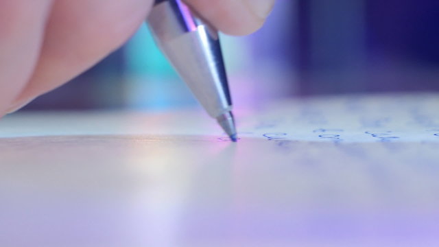 Pen writes a letter on paper