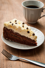 Slice piece of vanilla cake topping with white chocolate chips