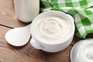 Sour cream in a bowl and milk bottle