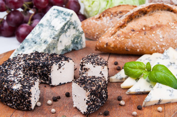 Assorted cheese on wooden board