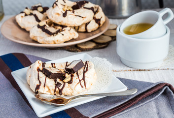 vanilla meringue with chocolate, caramel and nuts, sweet cake, a