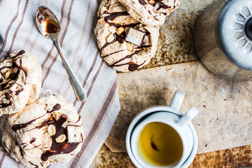 meringue cake with chocolate, caramel and nuts, dessert, rustic