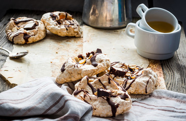 meringue cake with chocolate, caramel and nuts, dessert, rustic
