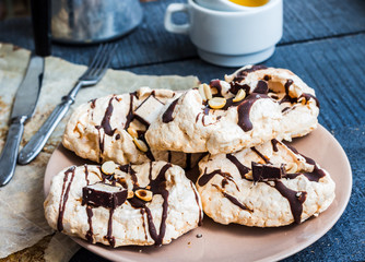 vanilla meringue with chocolate, caramel topping and nuts, sweet