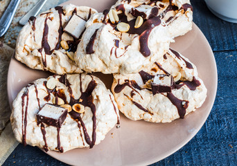 vanilla meringue with chocolate, caramel topping and nuts, sweet