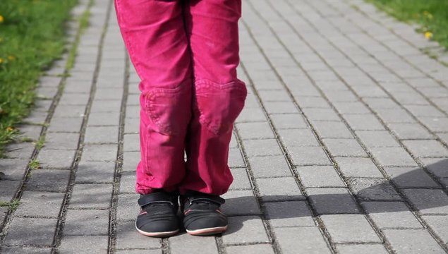 feet of little girl jumping rope