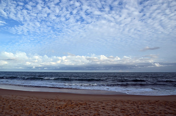 beach and blue cloudy sky by the sea on sundown