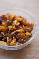 Heap of Raisins on vintage wooden background
