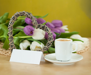 tulips on the table with cup of caffee