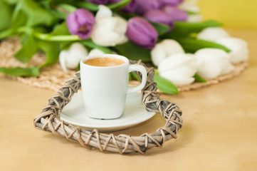 tulips on the table with cup of caffee