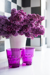 lilacs in a vase and glasses