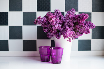 lilacs in a vase and glasses
