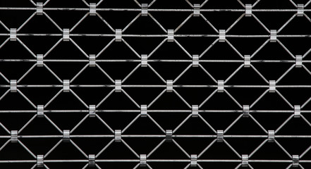 diamond shaped metal grid on black background