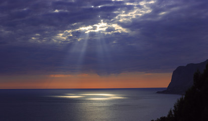 Sunset of Crimea. Cape Sarich. Rain of Black Sea.