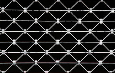 Fototapeta premium diamond shaped metal grid on black background