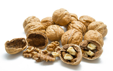 walnut and a cracked walnut on the white background