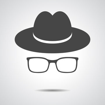 black hat with glasses on a grey background