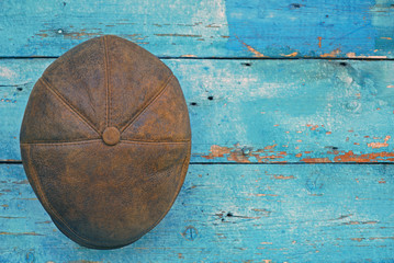 leather brown hat on wooden background