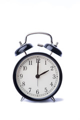 Black vintage alarm clock over the white background