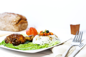 Oven cooked Chicken leg dish with rice side and vegetables