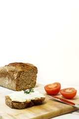 Bread lice with cream cheese and tomatoes on wood cutter 