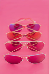 Collection of aviator stile sunglasses on pink background