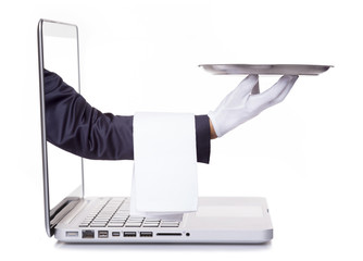 Waiter hand holding a silver tray through a laptop, isolated on