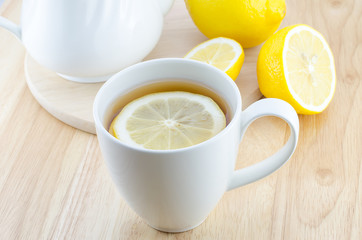 Cup of lemon tea on wooden table