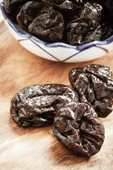 dried plums prunes on wooden table