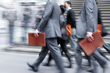 motion blurred business people walking on the street