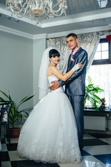 Fototapeta premium Charming bride and groom on their wedding celebration in a