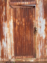 Fototapeta na wymiar grungy metal surface and lock on rusty iron door