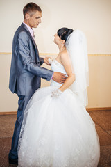 beautiful caucasian couple just married and dancing their first