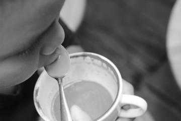 The boy is drinking green tea and milk.