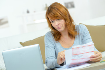 Woman with bills and computer