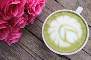Green tea and milk for drinking with artificial roses