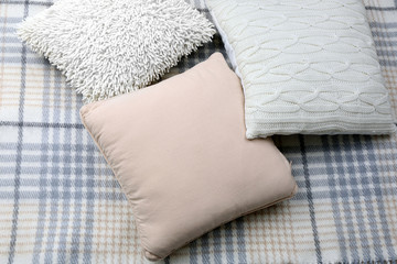 Decorative pillows on plaid close up