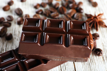 Stuffed chocolate with coffee beans on wooden table, closeup