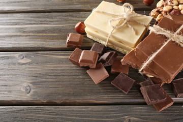 Set of chocolate with hazelnut on wooden table, closeup