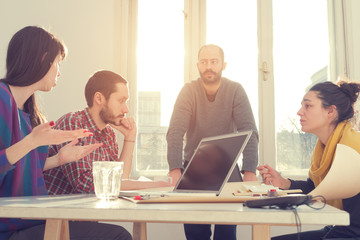 Young group of people discussing business plans.