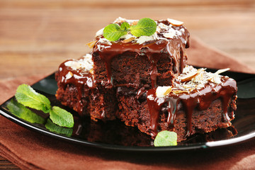 Delicious chocolate cakes on plate on table close-up