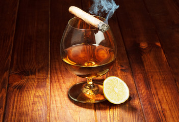 Cognac with lemon and cigar