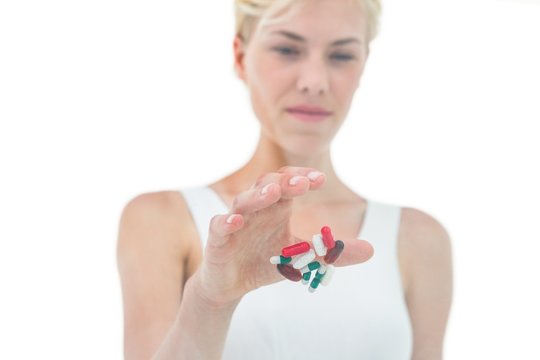 Blonde Woman Throwing Away Batch Of Pills